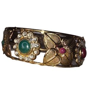 Gold tone embossed bracelet green red accents